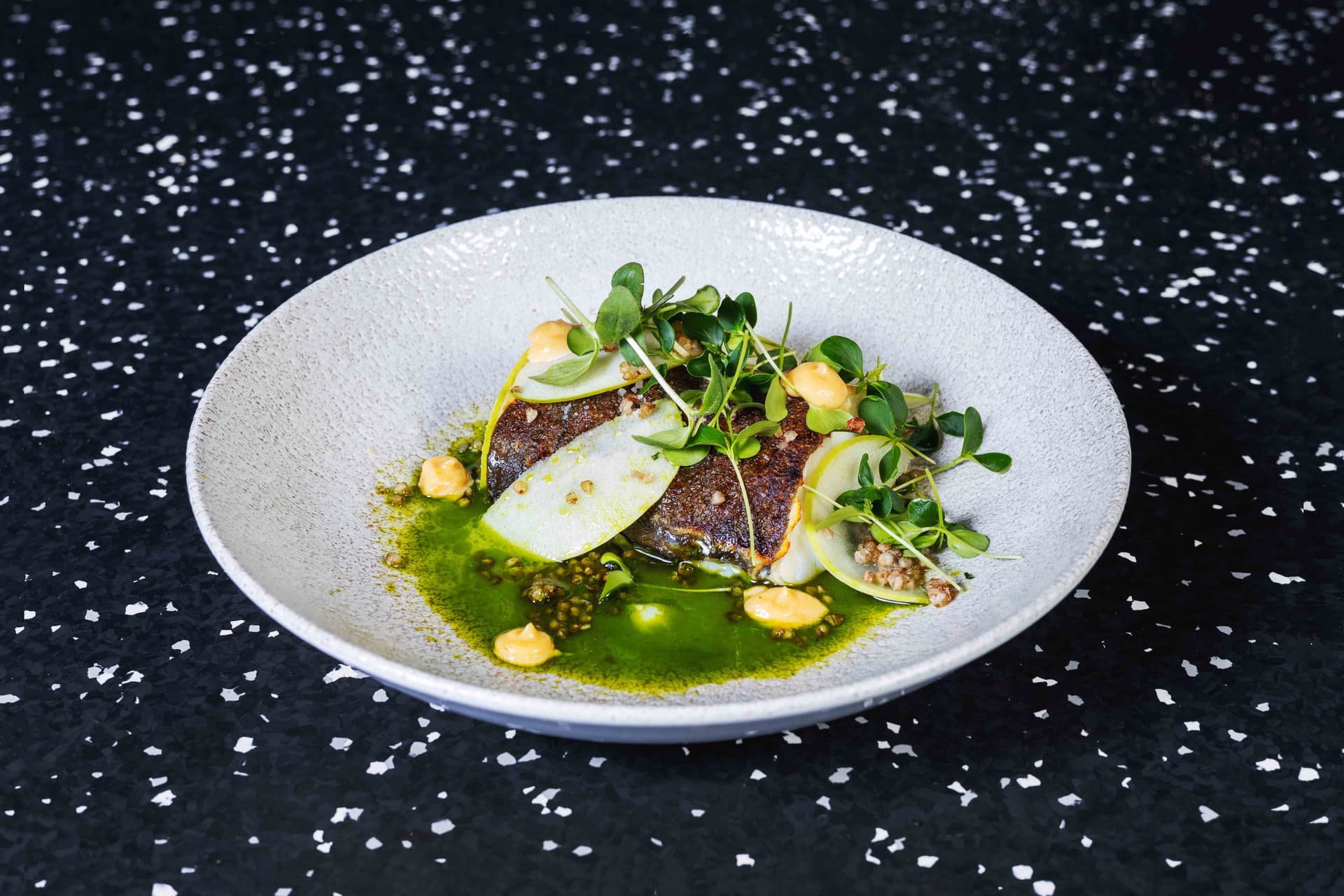 <p>Crispy grilled Skrai fillet, wild garlic oil, green apple, miso mayonnaise, crispy buckwheat</p>