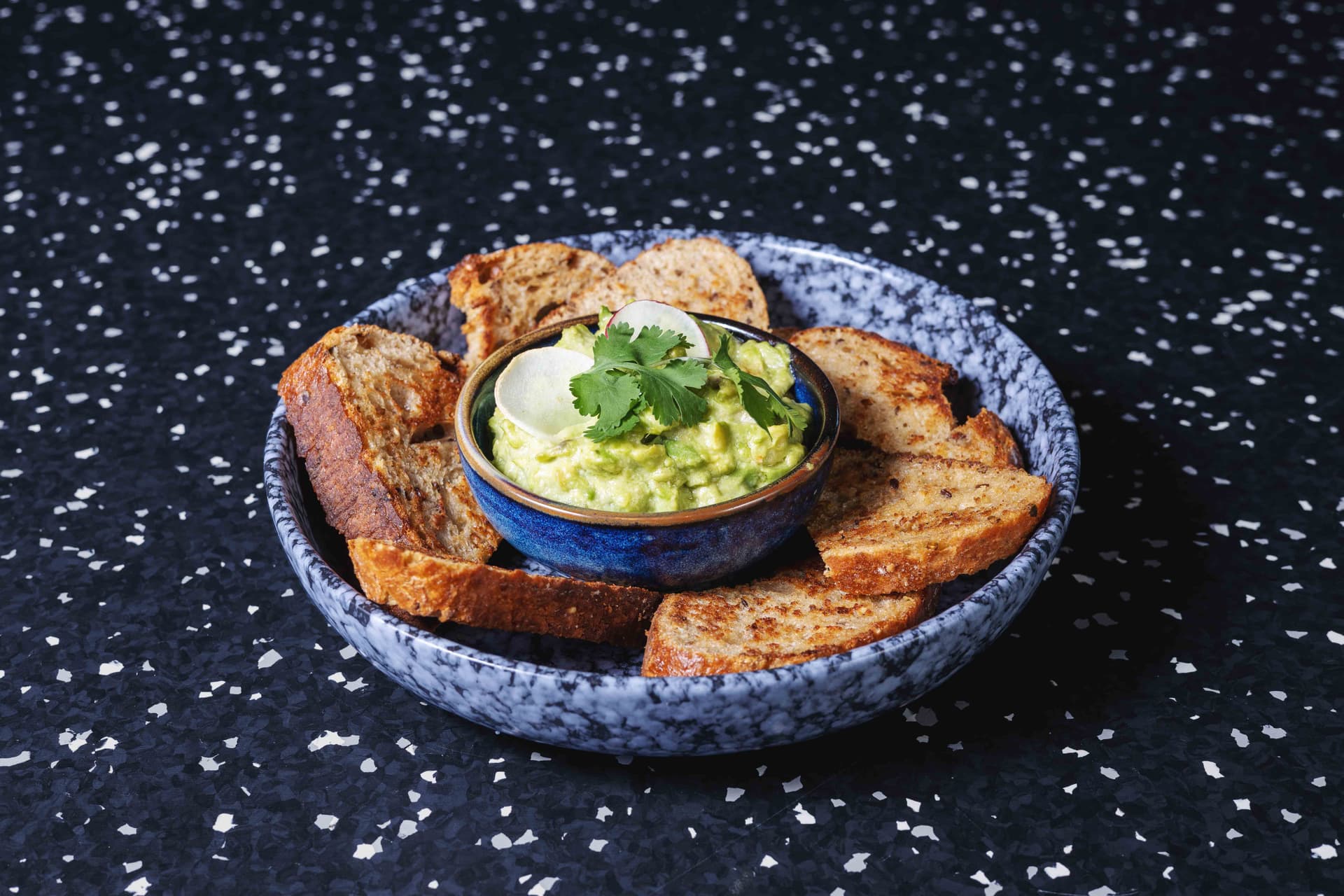 <p>Avocado, fresh lime juice, olive oil, salt and roasted sourdough bread</p>