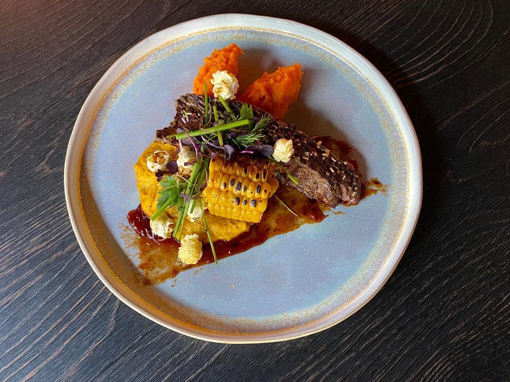<p>Grilled flank steak with mashed sweet potatoes &amp; roasted corn on the cob</p>