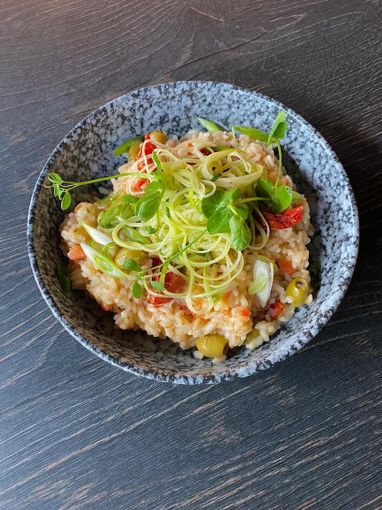 <p>Mediterranean risotto with green olive, semi-dried tomatoes and marinated courgettes</p>