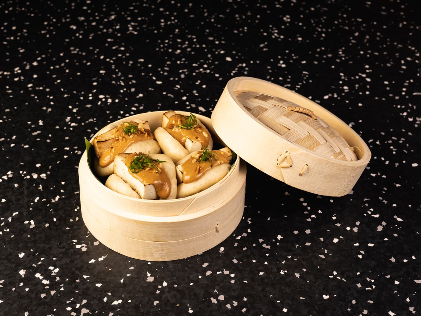 <p>Steamed bao bun, soy-marinated tofu, peanut sauce and roasted peanuts</p>