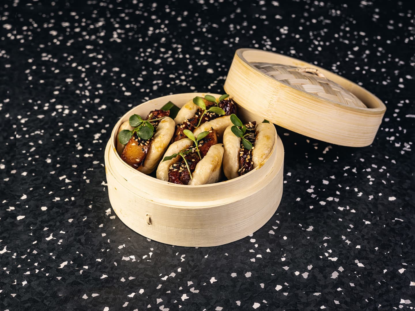 <p>Steamed bao bun, pork belly, lime glaze, sesame and garden cress</p>