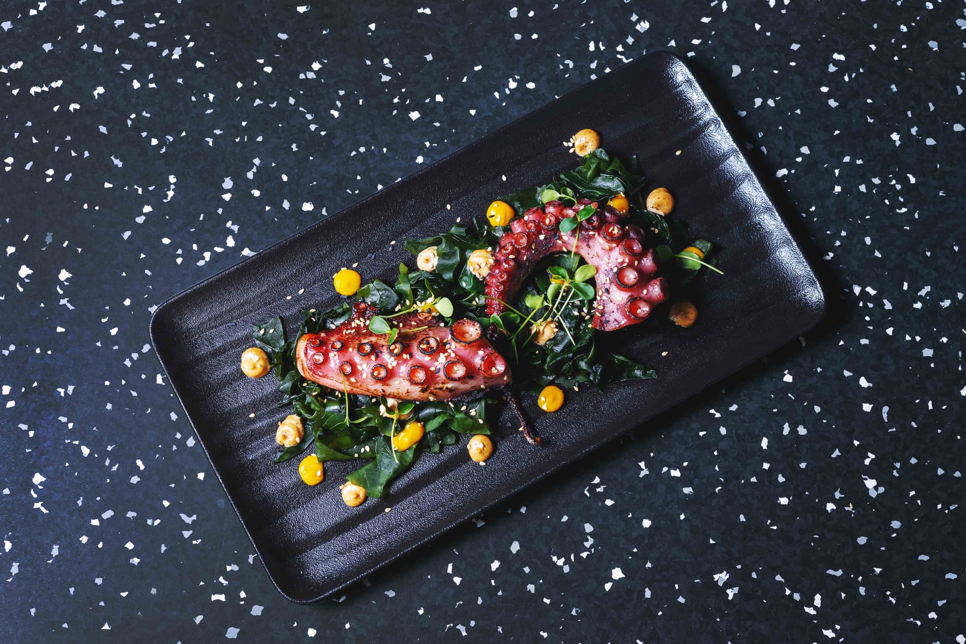 <p>Grilled octopus, whole wakame leaves, sesame, dashi, kumquat</p>