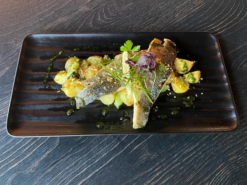 <p>Grilled sea bream fillet with potatoes &amp; cucumber salad</p>