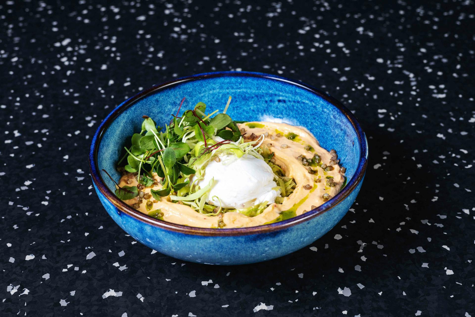 <p>Fine strips of marinated green cabbage, poached egg, Shiso leaves, ssanjang foam, sakura herbs</p>