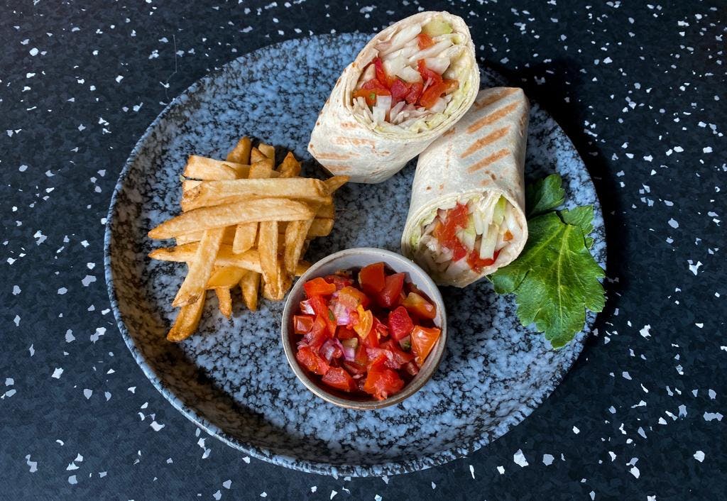 <p>Vegetable wrap with tomato salsa and French fries</p>