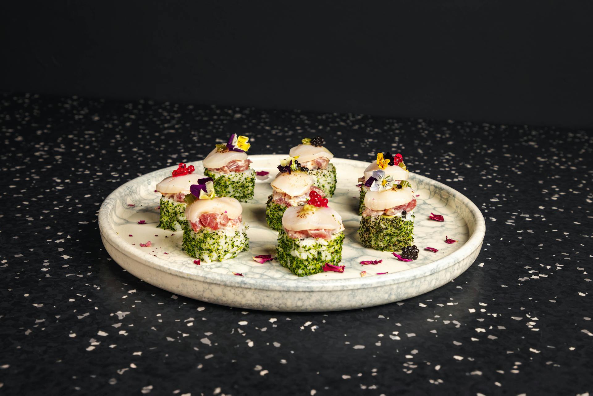 <p>Crab mayo, avocado spicy tuna, topped torch scallops&nbsp;</p>