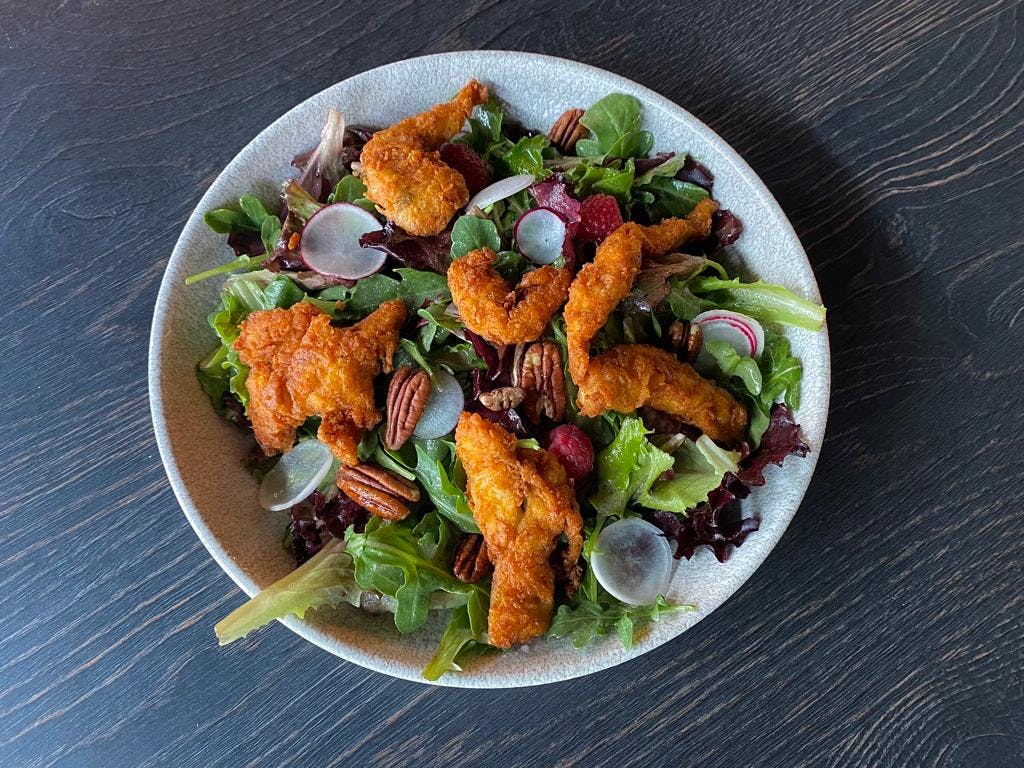 <p>Spring salad with fresh berries, raspberry-mustard vinaigrette, crispy chicken stripes and roasted pecans</p>