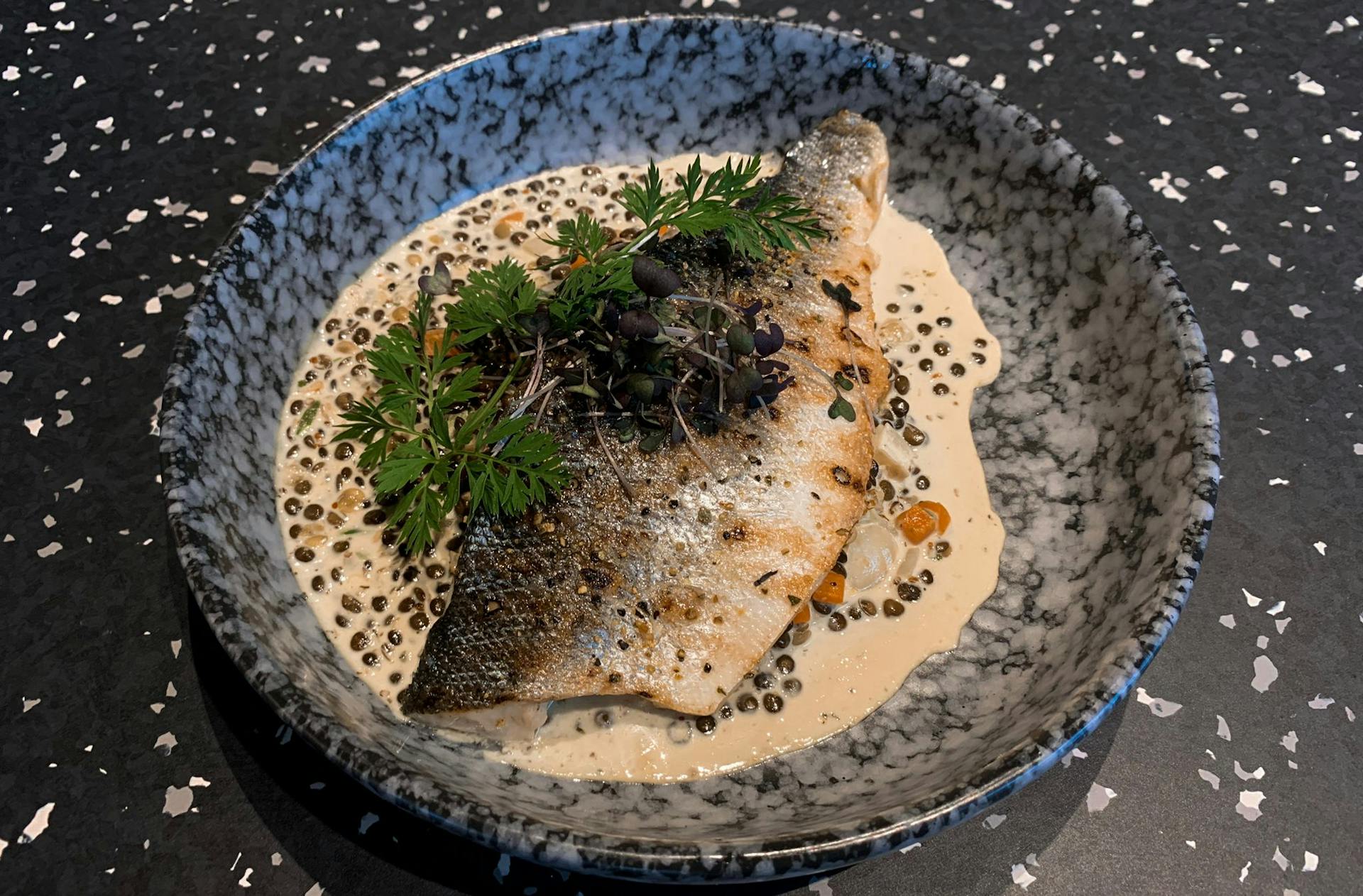 <p>Sea bass fillet with mustard sauce, lentils and root vegetables</p>